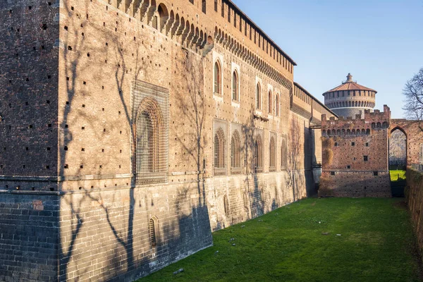 stock image A fragment of the facade of the castle with tower at sunny day in Milan, Italy