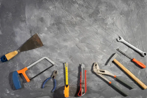 All tools supplies home construction on the gray wooden background. Building tool repair equipments,copy space,industry engineer tool concept.still-life.