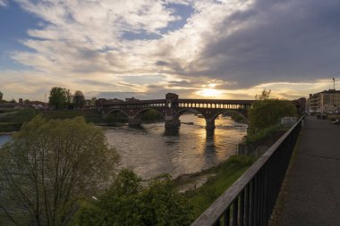harika Ponte Koperto (kaplanmış köprü) Pavia 'daki Ticino nehri üzerinde günbatımında, Lombardy, İtalya.