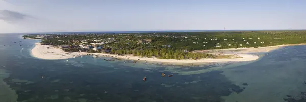 Panorama of coastline at sunny day, drone view of Kendwa beach, turquoise ocean,palm tree, luxury resort and people, Zanzibar,Tanzania