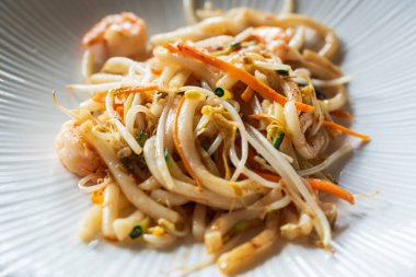 Lokantada karides, sebze ve soya soslu kızarmış Yaki Udon eriştesi. Japon yemekleri. Yakın çekim..