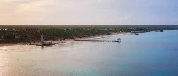 stock image Dominican Republic Bayahibe beach at sunrise, panorama view of coastline and lighthouse. Crystal clear sea with beautiful sandy beach.