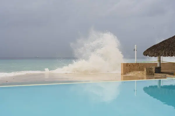 stock image Wonderful heavy sea, big waves crashing into the pool,background rain clouds, Hurricane arrived near the coast of the Dominican Republic,Bayahibe .