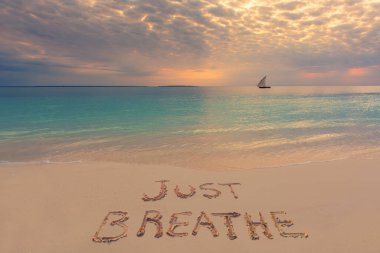 El yazısı Gün batımında kumlu sahilde nefes al, Zanzibar, Tanzanya.