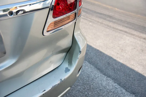 A car has a dented rear bumper after an accident get damaged