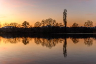 Günbatımında suya yansıyan ağaçların sonbahar manzarası. Sonbahar manzarası. Bas-Rhin, Alsace, Grand Est, Fransa, Avrupa.