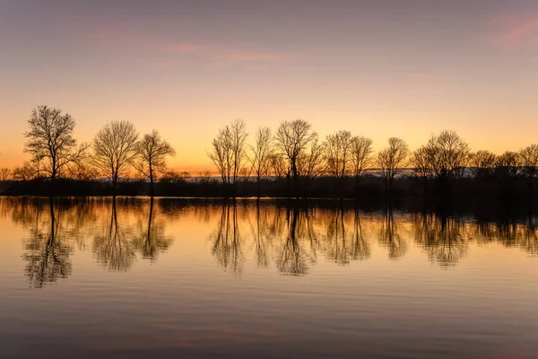 Autumn landscape of trees reflecting in the water at sunset. Autumn landscape. Bas-Rhin, Alsace,Grand Est, France, Europe.