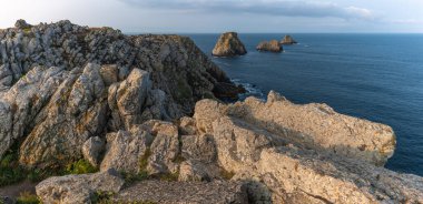Pen Hir 'in ucu ve bezelye yığınları. Kayalar pürüzlü ve pürüzlü, su da sakin. Sahne huzurlu. Camaret emin mer, Crozon, Finistere, Fransa, Avrupa.