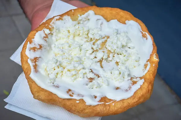 stock image Langos with sour cream and cheese, a typical Hungarian food.