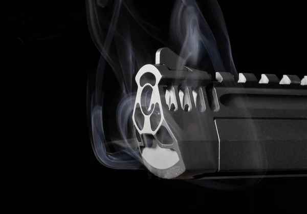 Smoking semi-automatic pistol on a black background