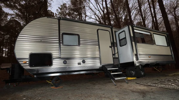 Camper trailer in a dark forest near Jordan Lake in North Carolina