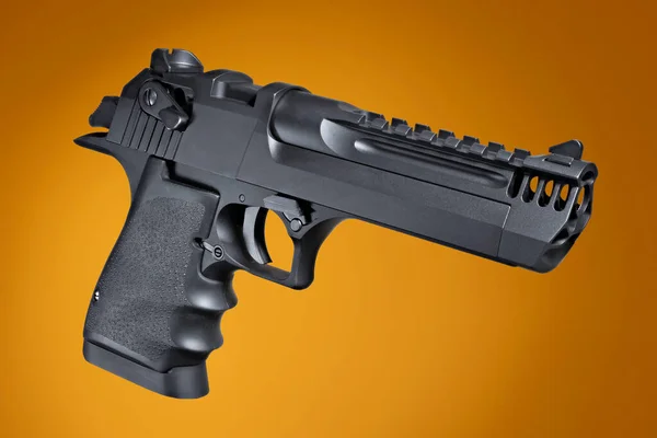 Semi auto handgun quartering on an orange background
