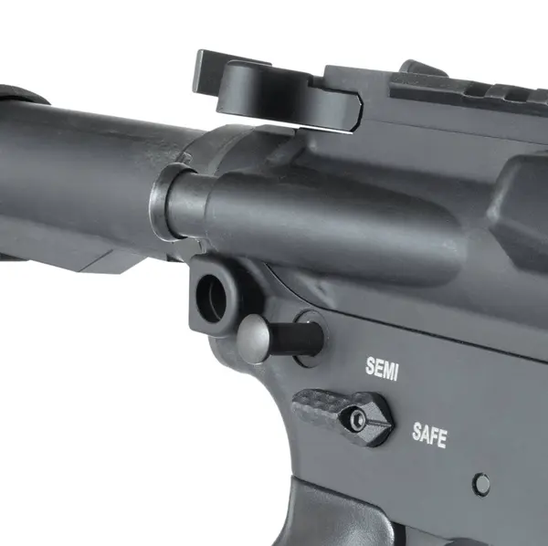 stock image Takedown pin at the back of the lower receiver of an AR-15 partially out isolated in a studio shot.