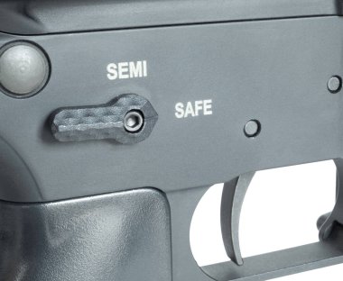 Ambidextrous safety selector on an AR-15 in the safe position with the trigger visible in a studio shot. clipart