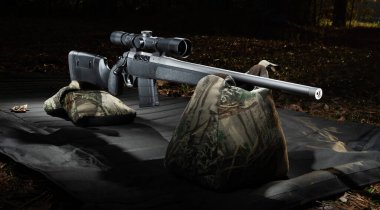 Bolt action rifle and sandbags in the early morning ready to be sighted in. clipart