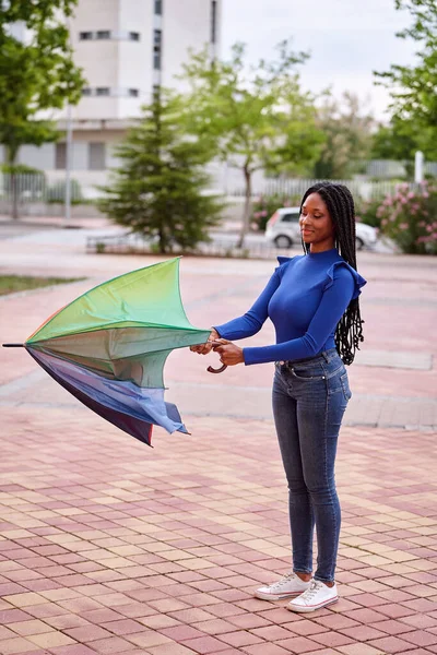 アフリカ系アメリカ人の女性が傘を持って通りの外に立つと — ストック写真