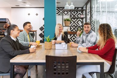 Ofiste kahve molası verirken gülümseyen ve konuşan iş arkadaşları. İş konsepti.