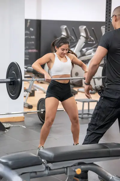 Focused Woman Sportswear Performing Barbell Lifts Personal Trainers Assistance Gym Stockfoto