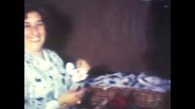 palermo, italy december 1970: bride and groom give favors as a souvenir of the wedding anniversary in the 70s