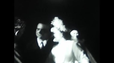 palermo, italy december 1940: the couple greets guests and exits the church in black and white in the 1940s.