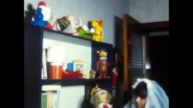 palermo, italy may 1980: A girl in a bedroom dressed in white in the 80s