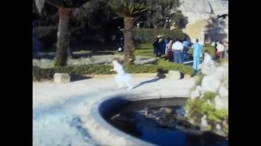 palermo, italy may 1980: children run in the garden in the 80s