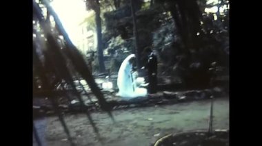 palermo,italy december 1980: happy bride and groom kiss in a park in the 80s