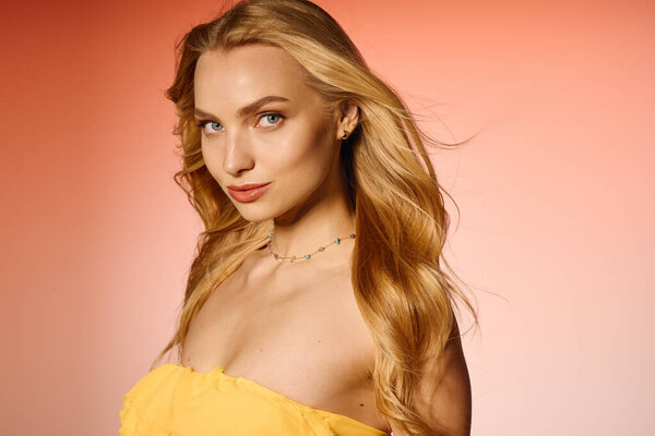 A beautiful young woman showcases her trendy fashion sense against a warm, colorful backdrop.