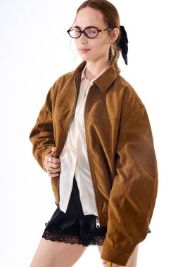 Şık, genç bir kadın şık bir elbise içinde şık bir şekilde poz veriyor. Benzersiz tarzını vurguluyor..