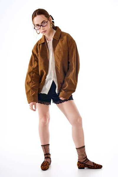 A stylish, confident young woman showcases her trendy outfit and unique accessories.