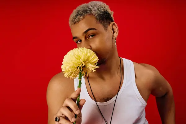 A young Black man flaunts his style with dyed hair in a lively studio. — Stock Photo