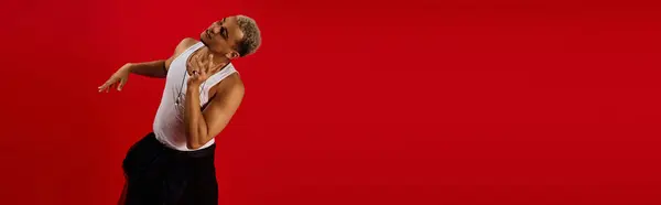 A young man with dyed hair dancing joyfully, exuding fashion, banner — Stock Photo