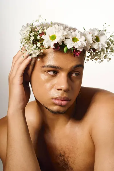 A shirtless young man with dyed hair poses confidently, showcasing his beauty in a studio. — Stock Photo