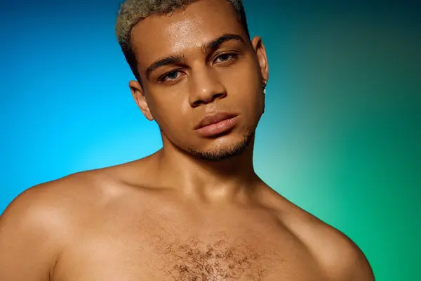 A young african american man with dyed hair poses confidently in a bright studio setting. — Stock Photo