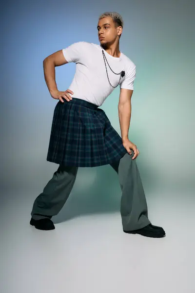 A confident young man poses in a trendy outfit, highlighting modern fashion diversity. — Stock Photo