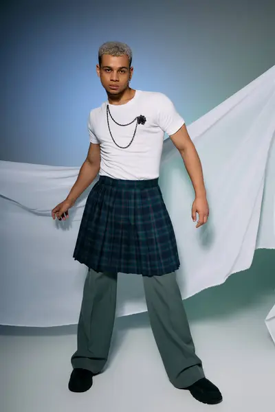 A young African American man with dyed hair poses confidently in a stylish outfit. — Stock Photo