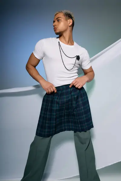 A stylish young man poses confidently in a trendy outfit with dyed hair. — Stock Photo