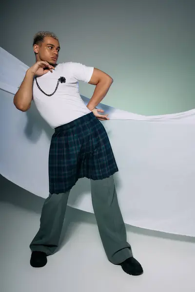 A young Black man with dyed hair poses confidently in a stylish outfit, expressing his uniqueness. — Stock Photo