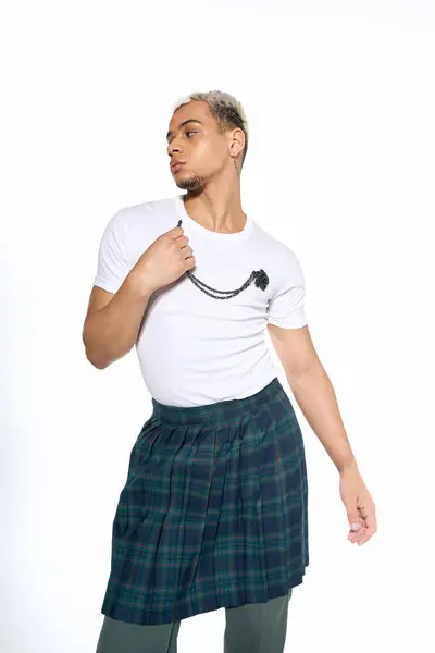 A confident young african american man displays a unique fashion sense in a studio. — Stock Photo