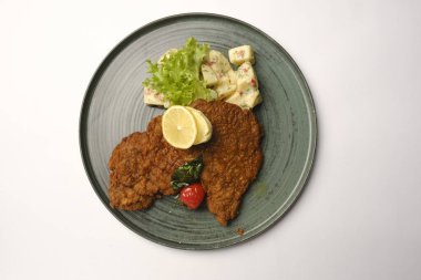 Patates kızartmasıyla servis edilen lezzetli şnitzel.