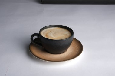 Masanın üzerinde bir fincan kahve. 