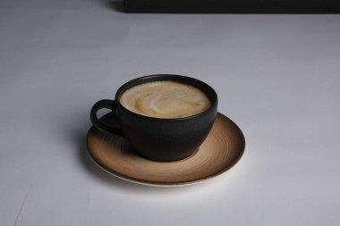 Masanın üzerinde bir fincan kahve. 