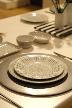 utensils, plates standing on the shelf in the store clipart