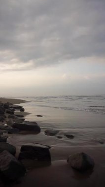 Güzel dikey plaj portresi videoları, sabahları manzara, Cipatujah sahilindeki küçük dalgaların görüntüsü.