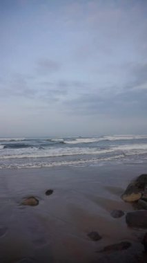 Güzel dikey plaj portresi videoları, sabahları manzara, Cipatujah sahilindeki küçük dalgaların görüntüsü.