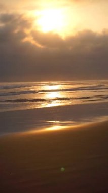 Öğleden sonra güneşin battığı sahil manzarasının güzel dikey videosu. Pangandaran Sahili