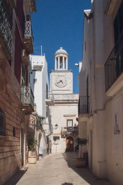 Clock tower built in limestone in Locorotondo, Italy. Today the civic library is part of what was the communal palace whose original building dates from the 18th century.