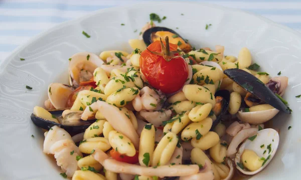 Cavatelli pasta dish with seafood in Polignano a Mare, Italy. Italian cuisine dish freshly served and ready to eat.