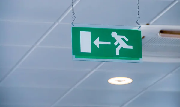 Emergency exit sign at Bari-Palese airport, Aeroporto Internazionale di Bari-Karol Wojtyla, Italy. Signaling of the location by means of a sign with a pictogram.
