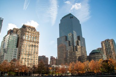 Cityscape of skyscrapers next to ground zero in New York in autumn. The West Street Building skyscraper and to its right the skyscraper 205 Albany Street in November 2019. clipart